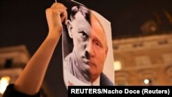 Una recreación de los rostros de Putin y Hitler en una protesta en Barcelona, España contra la invasión a Ucrania.