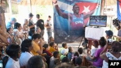 Familiares y vecinos del luchador Mijain López, en Herradura, Pinar del Río, siguen en la televisión la pelea por el oro en París 2024 que ganó el cubano. 